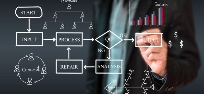 midsection-man-pointing-towards-chart-against-black-background (1)